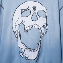 Load image into Gallery viewer, Close up of the back of a treated and washed baby blue zip hoodie with white embroidered skull with black outline embroidery