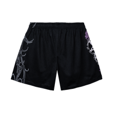 Load image into Gallery viewer, Back of a black mesh shorts with white and purple designs