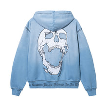 Load image into Gallery viewer, Back of a treated and washed baby blue zip hoodie with white embroidered skull with black outline embroidery

