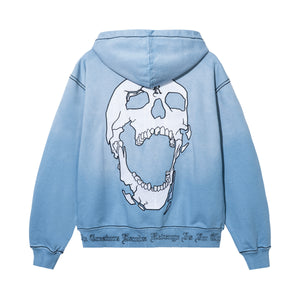 Back of a treated and washed baby blue zip hoodie with white embroidered skull with black outline embroidery