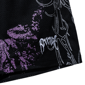 Close up of the bottom left of black mesh shorts with purple and white abstract design and a small white Revenge arch logo embroidered on the bottom left