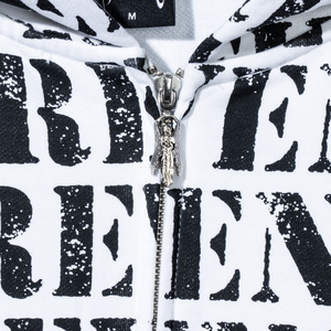Close up of a white zip hoodie with repeating REVENGE! in black distressed print and silver angel zipper puller