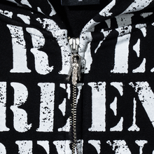 Load image into Gallery viewer, Close up of a black zip hoodie with repeating REVENGE! in white distressed print and a silver angel zipper puller
